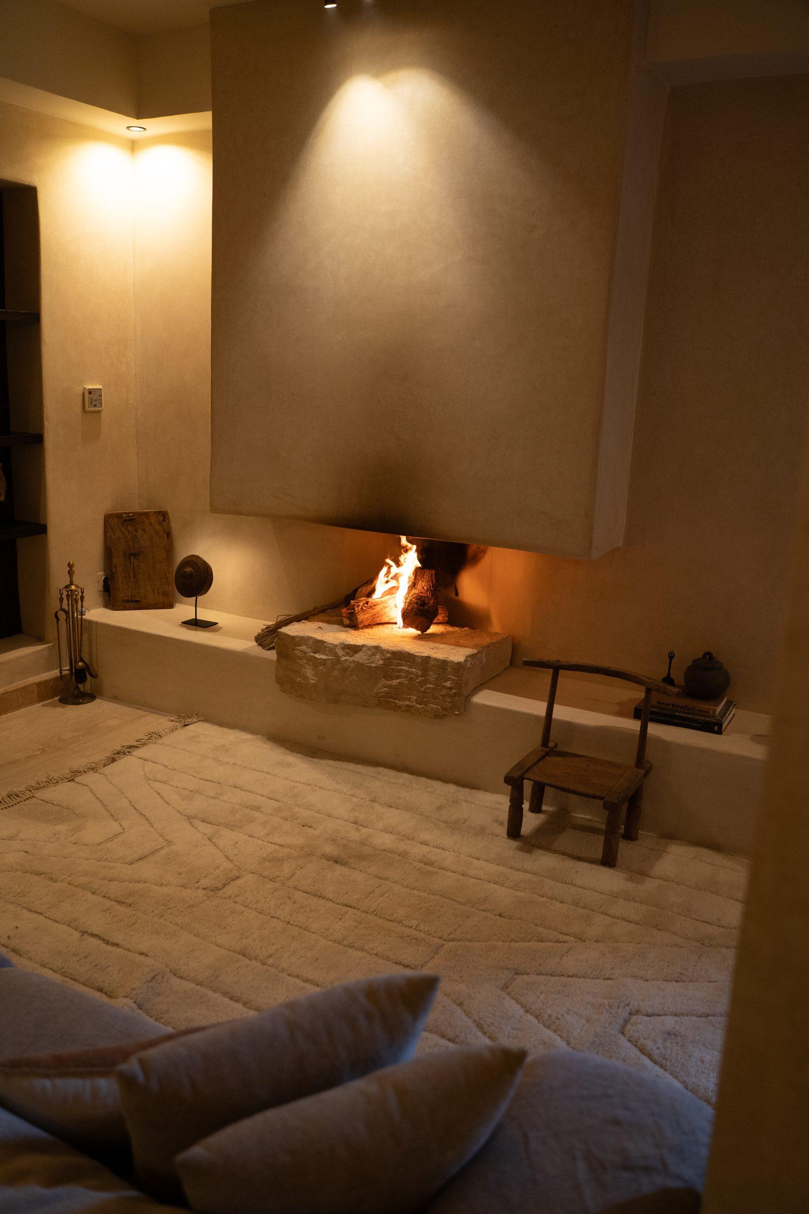 A Mrirt rug on the floor of a room with plaster walls