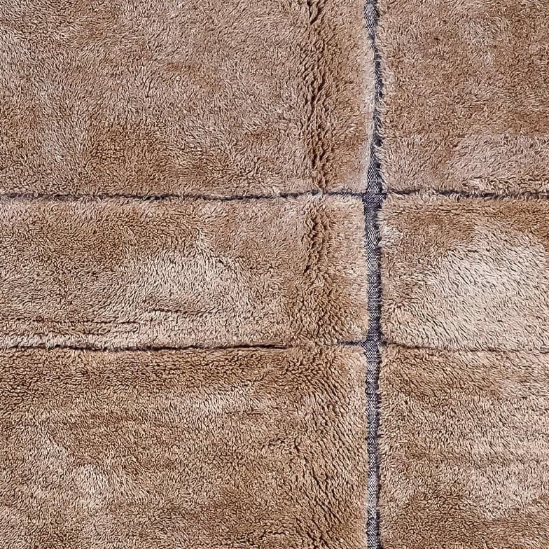 Gros plan d’une laine caramel, réglée de lignes tissées plus sombres
